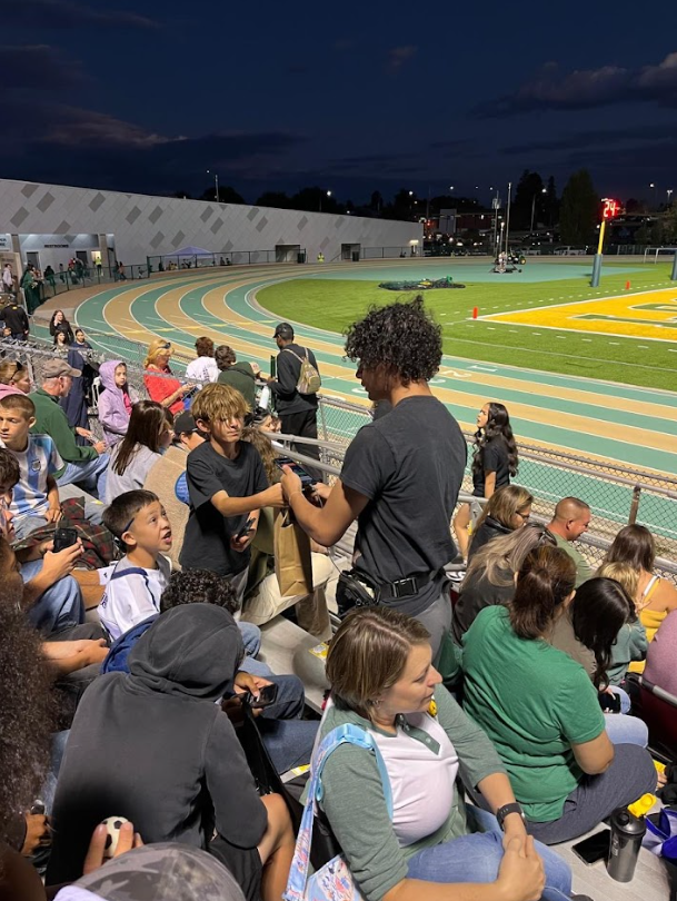 Delivery person handing order to customer in the stands